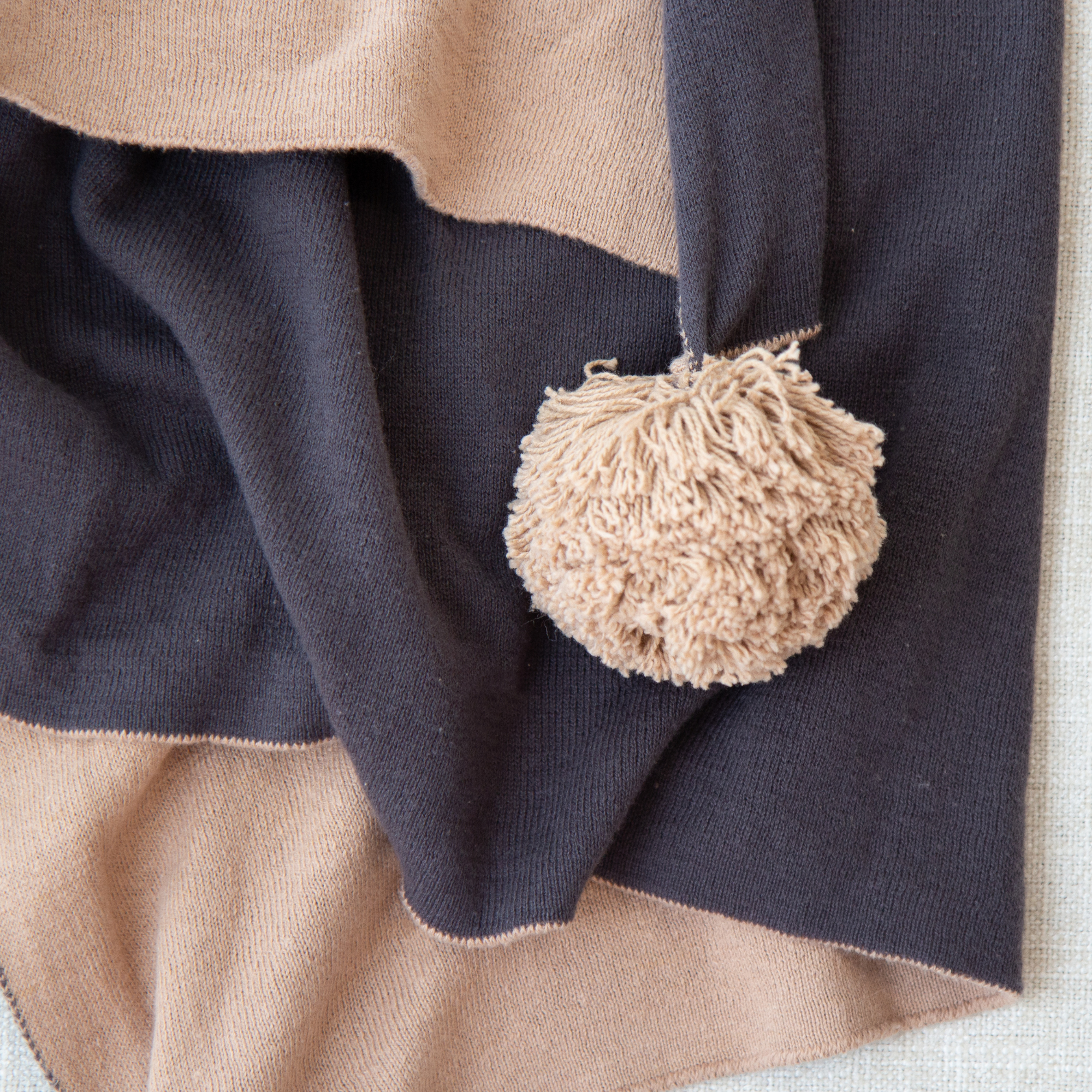 Dakota Double Sided Knit Throw with Pom Poms in Tan/Black - Image 2